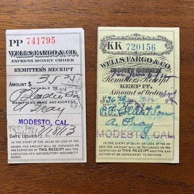 Two vintage Wells Fargo money order receipts on a wooden surface