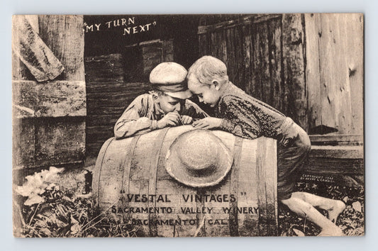 Sacramento California Vestal Vintages winery advertising postcard showing two children beside a wine barrel labeled Sacramento Valley Winery Vestal Vintages.