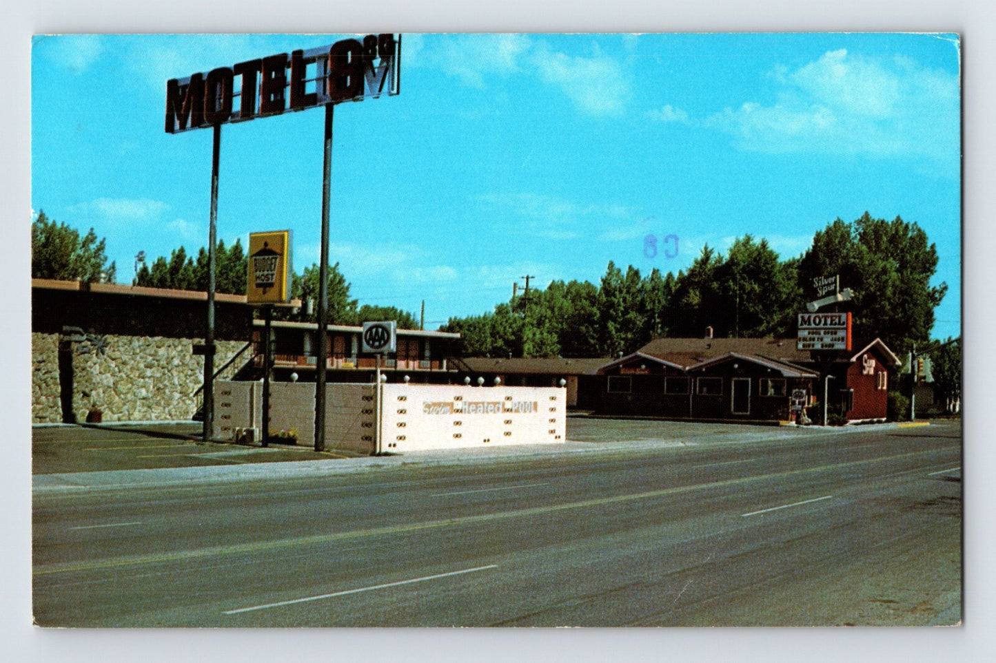 Laramie Wyoming Silver Spur Motel roadside view neon sign 1980s chrome postcard posted