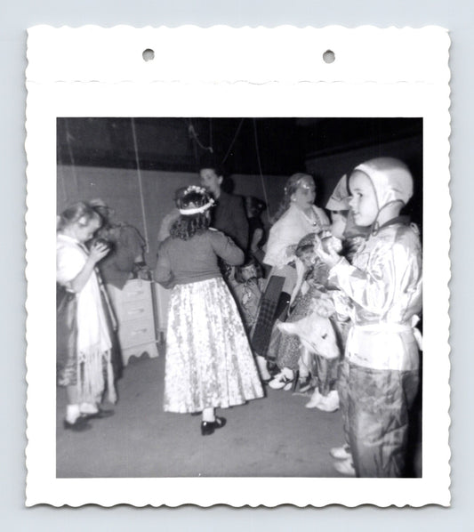 Children Halloween costume party dancing indoors mid century snapshot 1960s photo