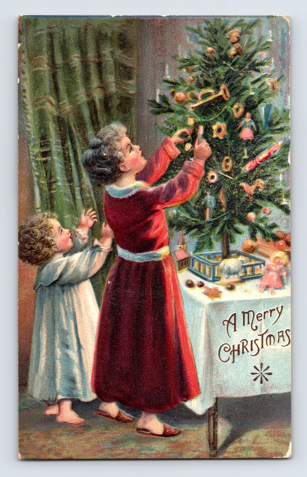 Children decorating Christmas tree indoor holiday scene 1910s postcard