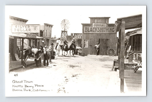 Buena Park California Knott’s Berry Place Ghost Town 1940s RPPC postcard with western storefronts, horseback riders, and blacksmith shop.