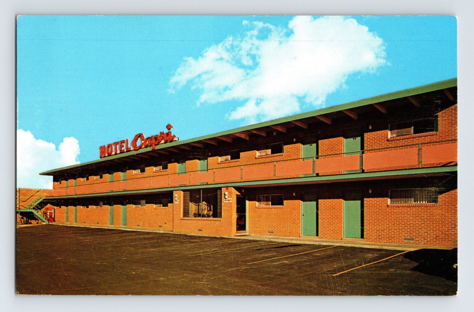 Kansas City Missouri Motel Capri 1960s postcard with two story brick motor lodge exterior and rooftop sign chrome finish