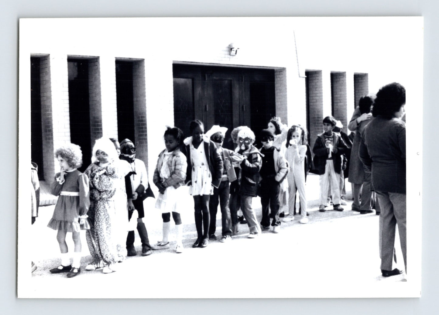 Children Halloween costume parade line outside school building snapshot photo 1960s