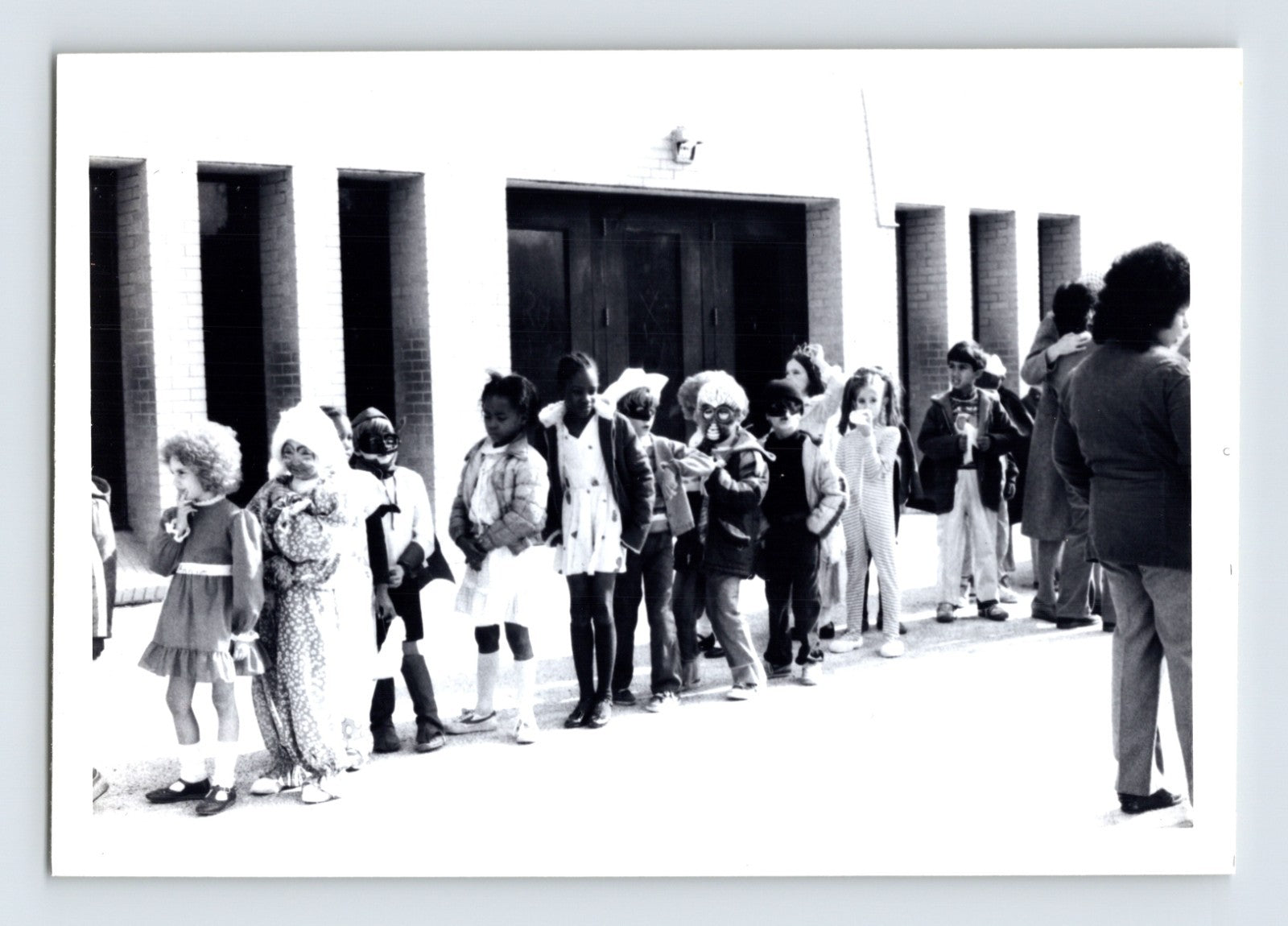 Children Halloween costume parade line outside school building snapshot photo 1960s
