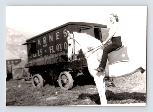 Barnes Sells Floto Circus 1940s woman performer riding white horse beside circus wagon photograph