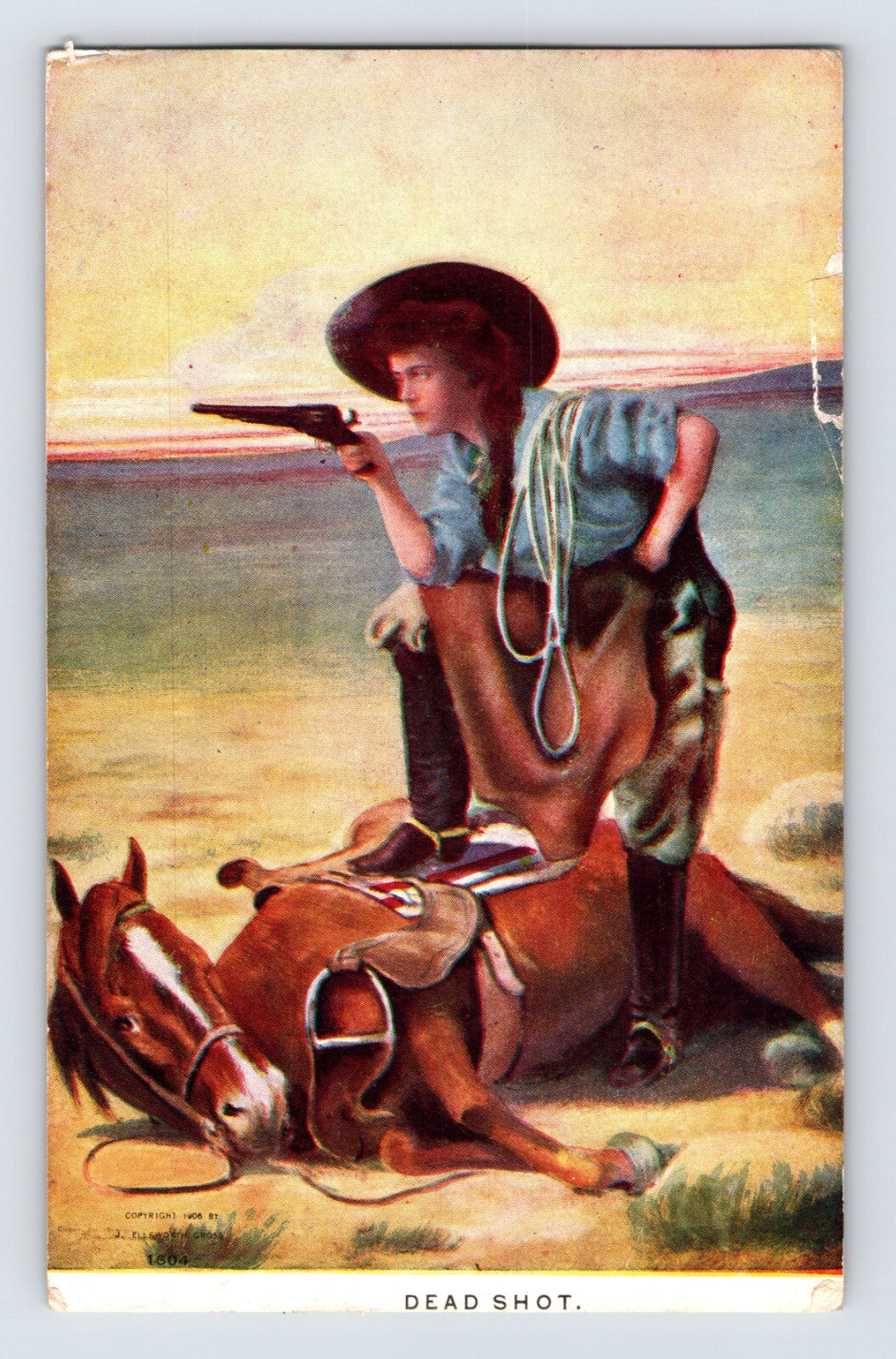 Illustrated cowgirl kneeling beside fallen horse aiming pistol across desert landscape in early twentieth century Western postcard art