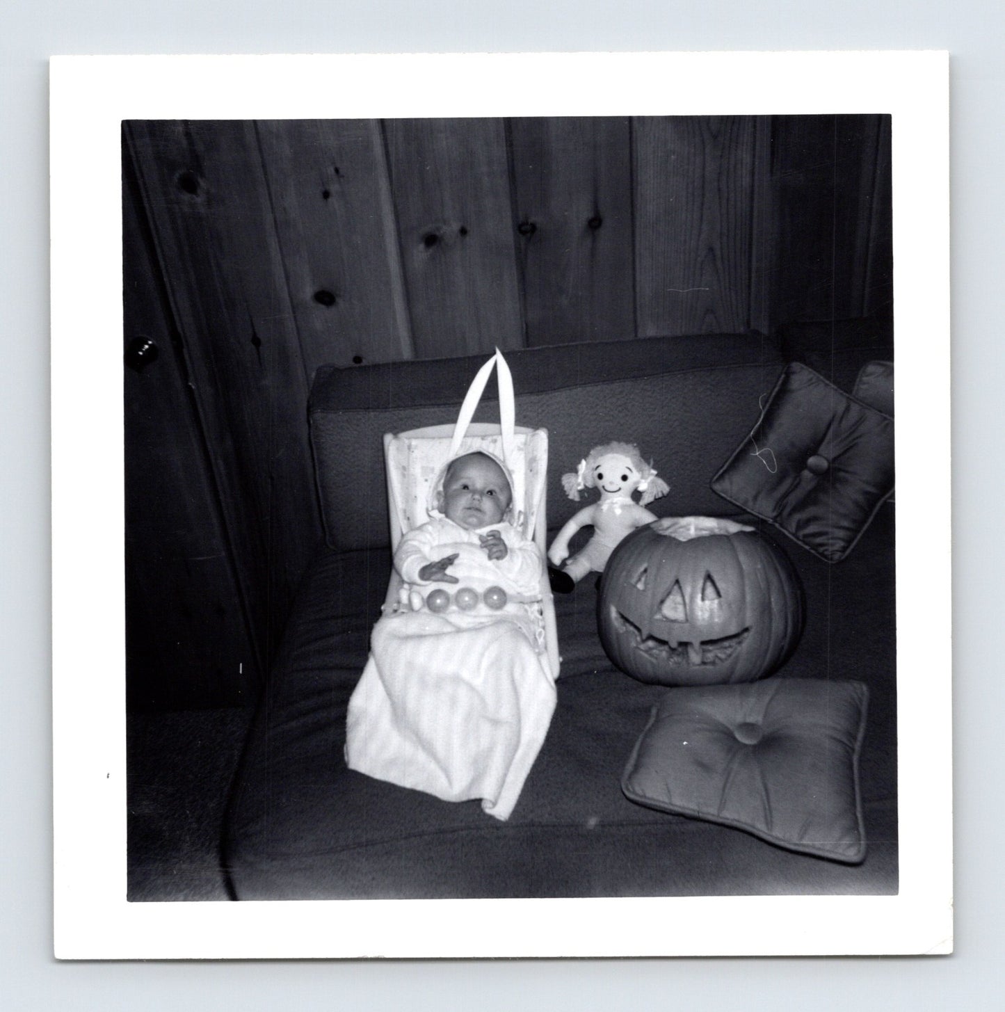 Vintage Halloween baby bassinet jack o lantern doll couch indoor 1963 snapshot black white photo