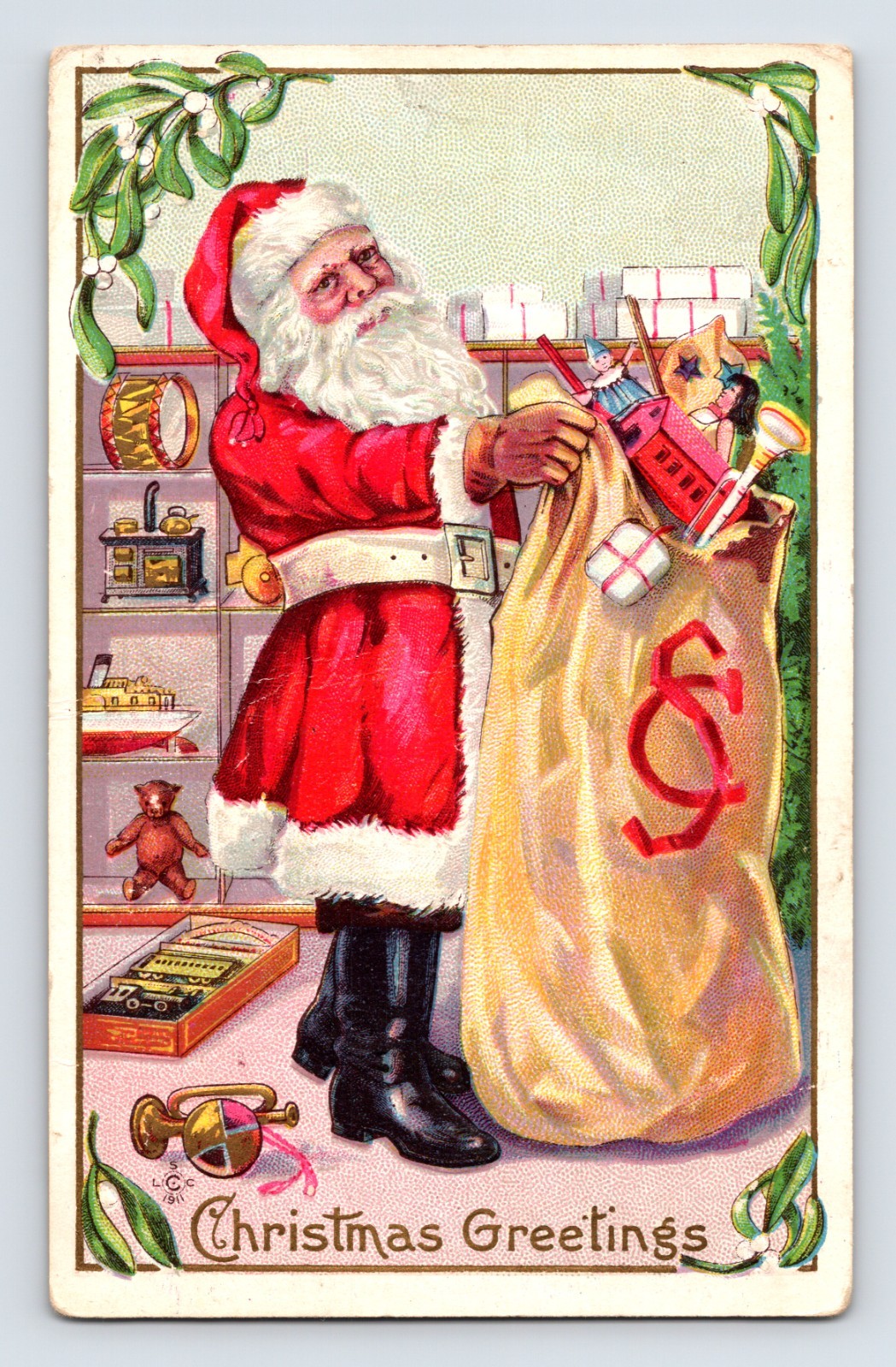 Santa Claus holding a large toy sack beside shelves of drums, trains, and dolls beneath mistletoe on this 1911 Christmas Greetings postcard.