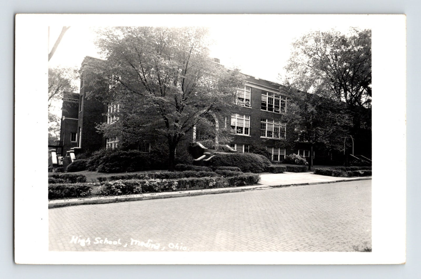 Medina Ohio high school building with trees landscaping and brick facade 1950s RPPC postcard