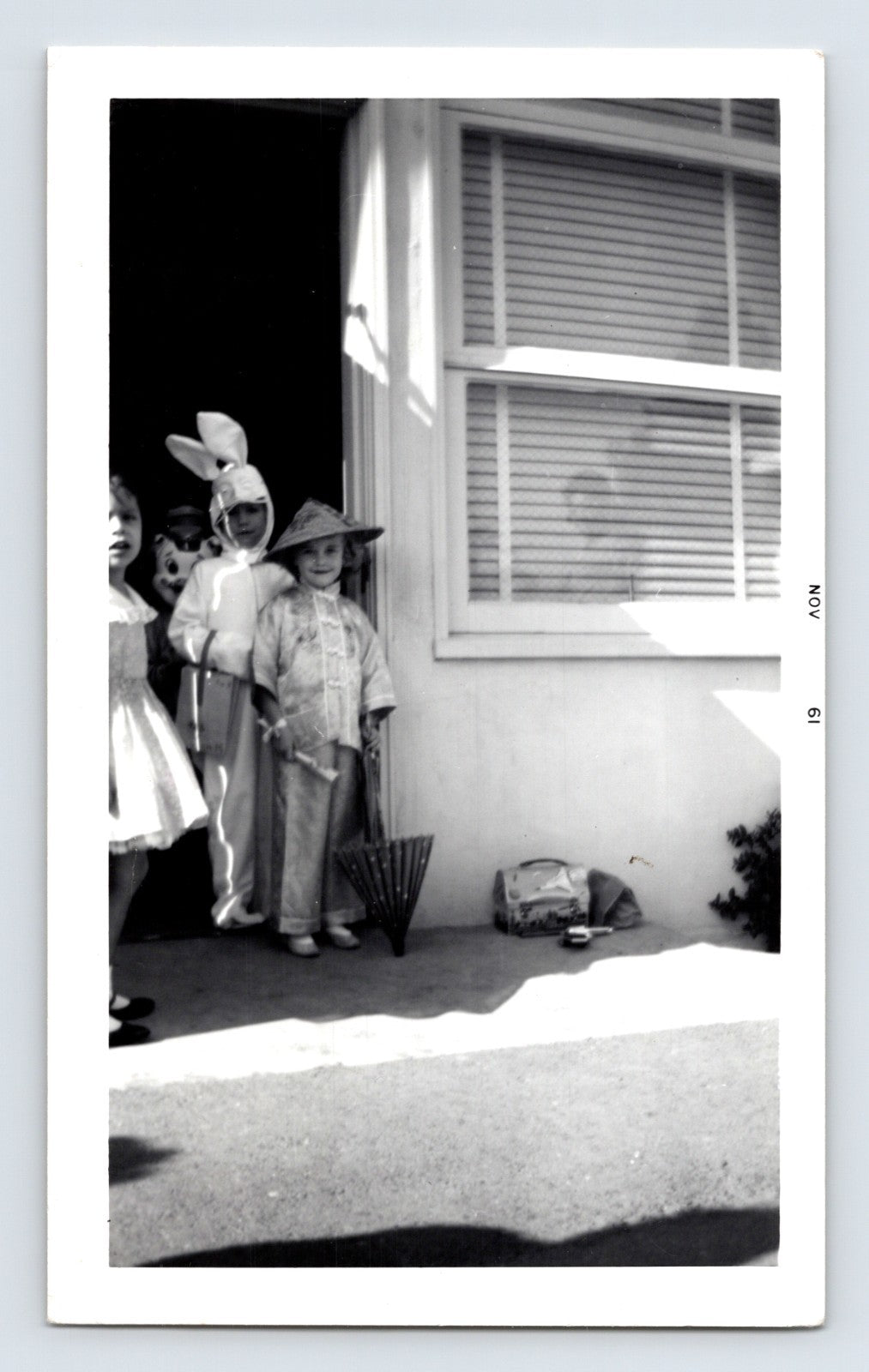 Halloween children bunny costume doorway trick or treat umbrellas 1950s snapshot
