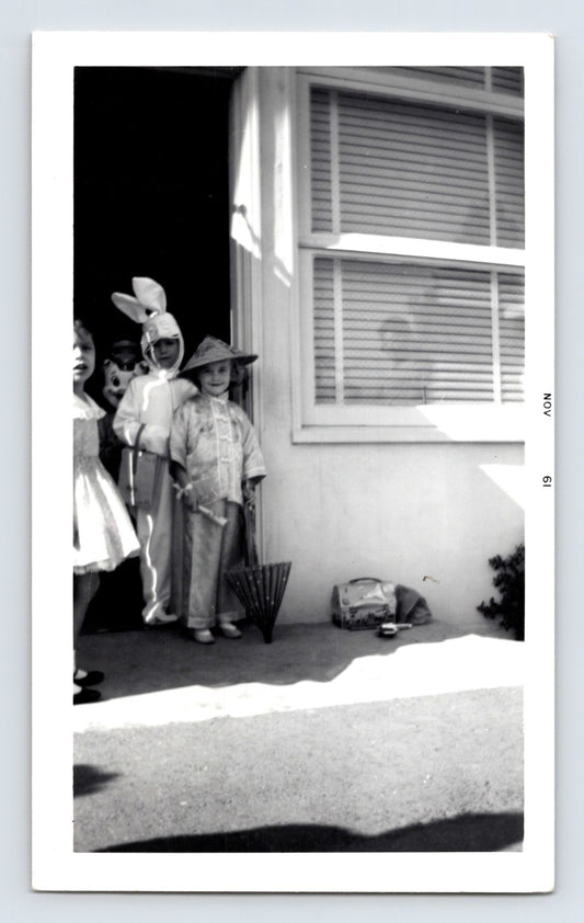 Halloween children bunny costume doorway trick or treat umbrellas 1950s snapshot