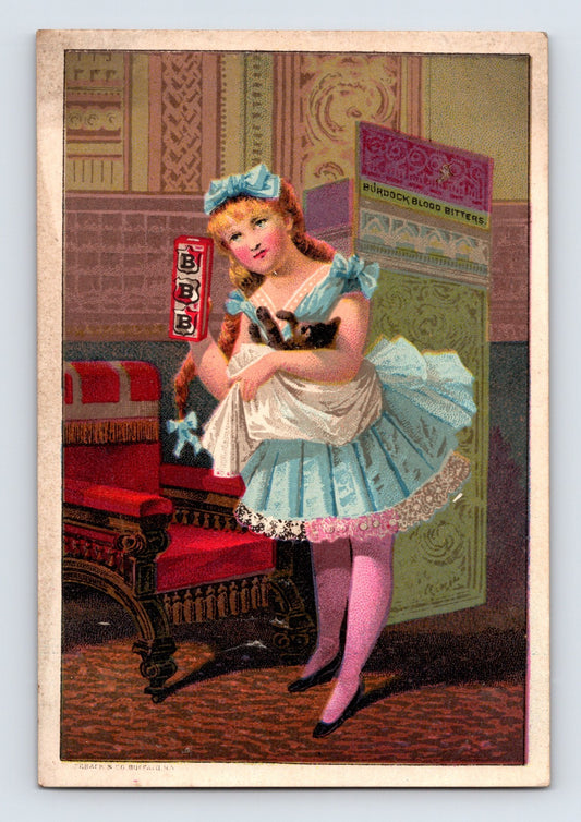 Victorian trade card featuring young girl with cat and Burdock Blood Bitters package beside ornate Victorian furniture and interior décor.