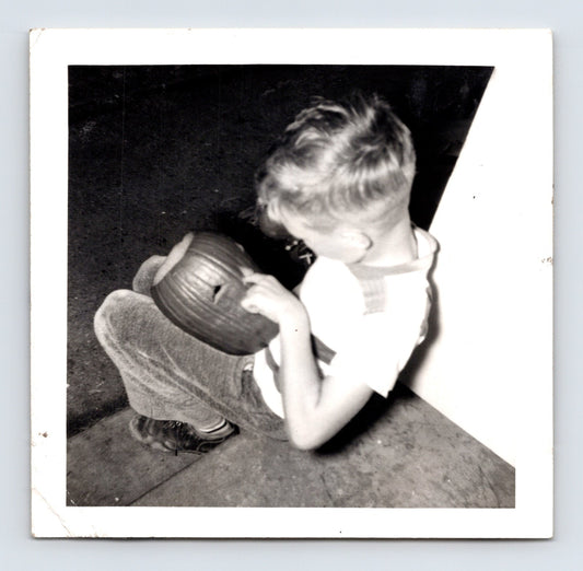 1940s Halloween boy carving jack o lantern pumpkin indoor snapshot square photo