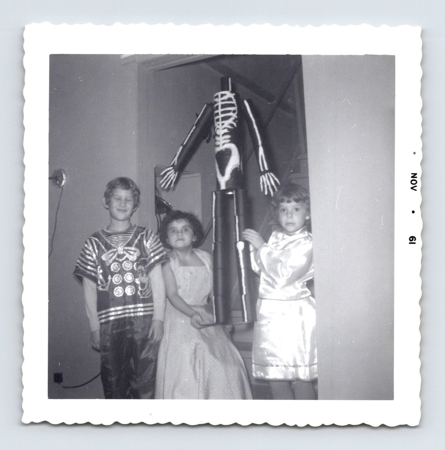 three children Halloween costumes skeleton decoration indoor November 1961 black and white photo