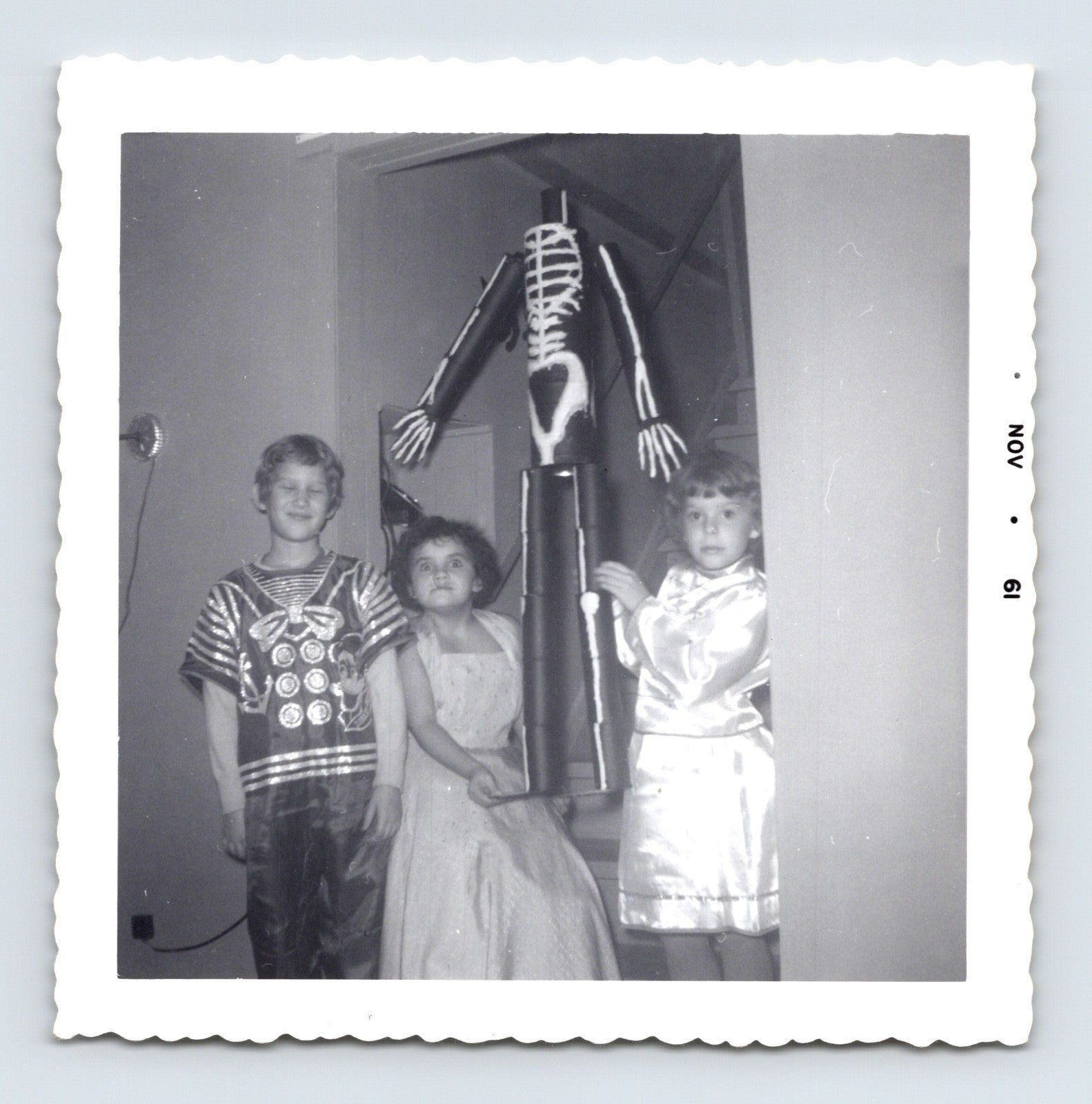 three children Halloween costumes skeleton decoration indoor November 1961 black and white photo