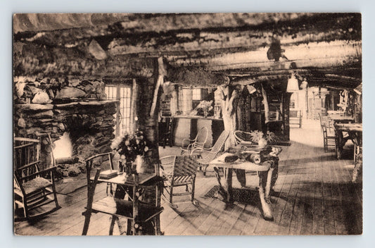 Sepia-tone postcard interior view of the Long Trail Lodge hotel lobby near Rutland, Vermont, featuring rustic log construction, stone fireplaces, and Adirondack-style furnishings.