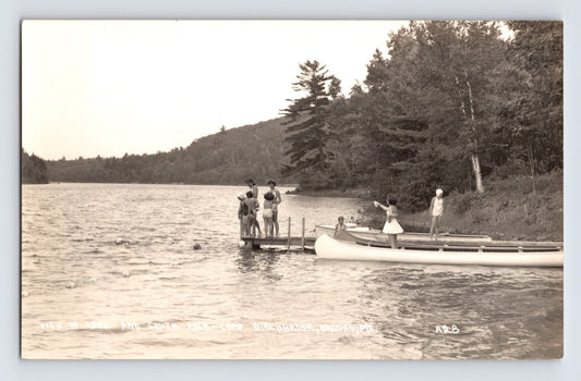 Birchbrook Maine camp scene with swimmers on wooden pier and canoe along wooded lakeshore 1940s real photo postcard