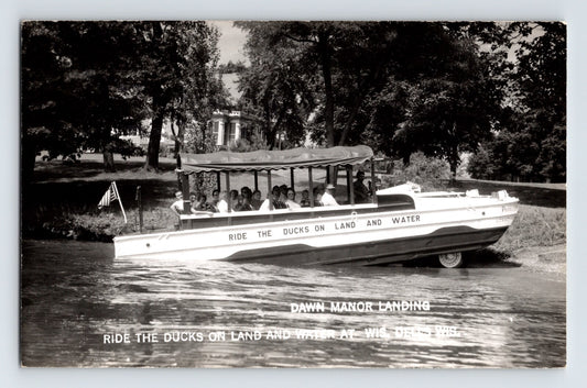 Wisconsin Dells duck boat at Dawn Manor Landing with passengers riding amphibious vehicle on water 1950s real photo postcard