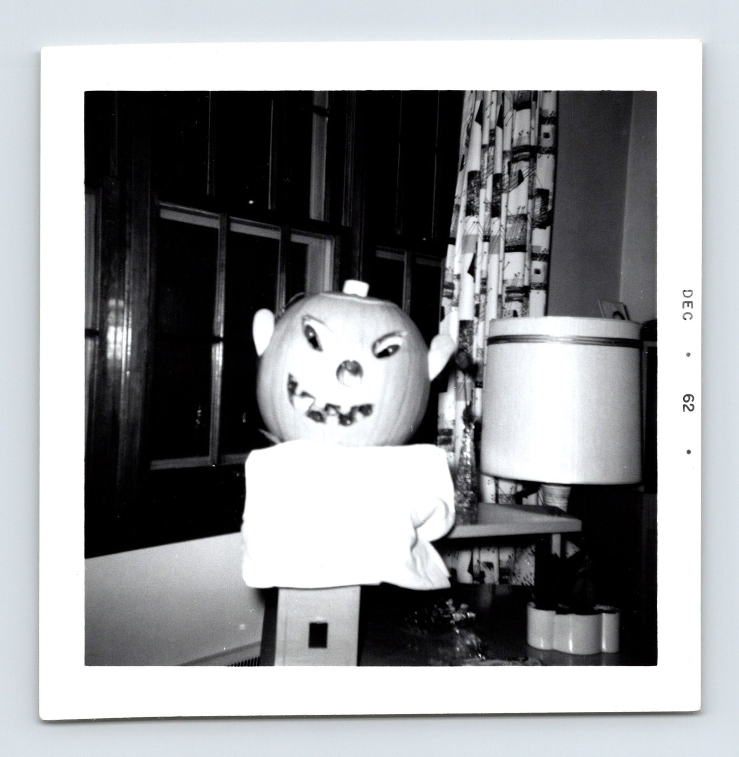 Halloween jack o lantern decoration indoor table lamp mid century living room December 1962 snapshot 3.5 x 3.5 photo