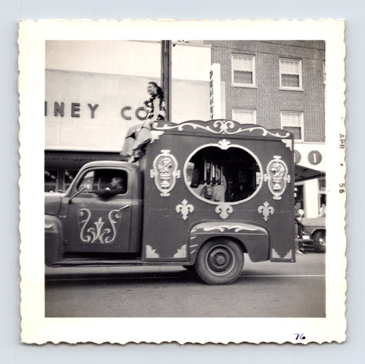 1955 Cole Bros Circus decorative parade truck snapshot photograph showing a costumed circus performer riding atop an ornate vehicle in downtown Decatur GA