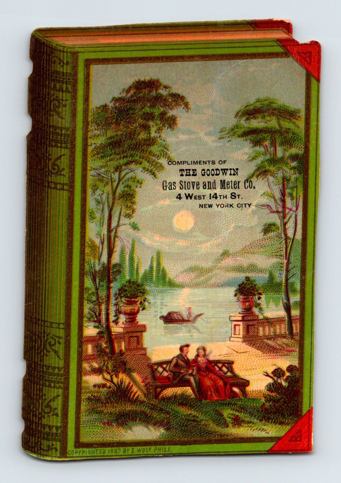 Die cut Victorian trade card shaped like a green book advertising Goodwin Gas Stove and Meter Company New York City with romantic lakeside garden scene 1890s