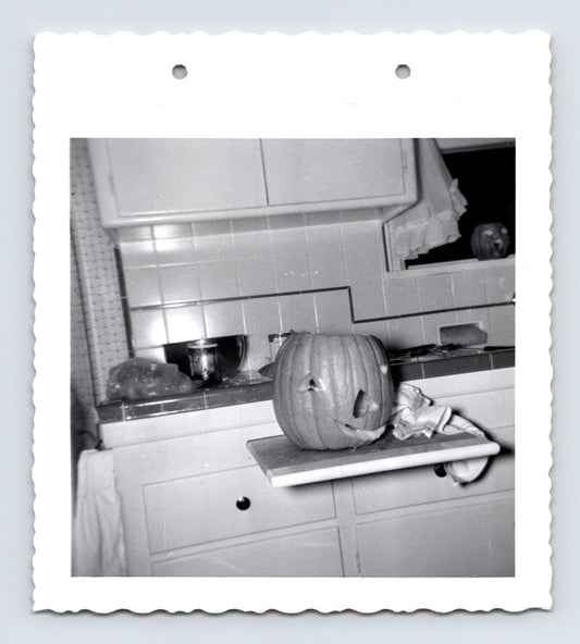 Halloween carved pumpkin jack o lantern kitchen counter mid century snapshot 1960s photo