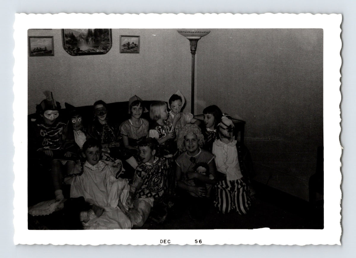 Halloween children group costumes masks living room party 1956 snapshot black and white photo