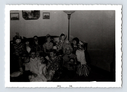 Halloween children group costumes masks living room party 1956 snapshot black and white photo