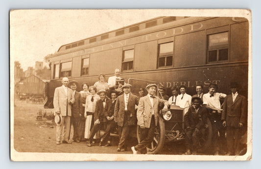 William Todd Show circus railroad car Wanderlust with performers and early automobile posed beside railcar, 1910s real photo postcard