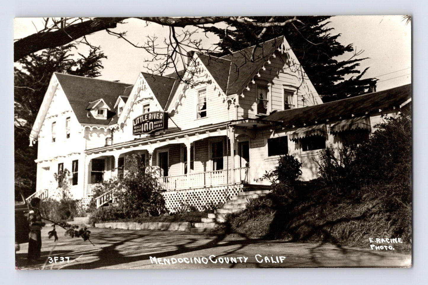 Postcard front showing the Little River Inn hotel with wraparound porch and gabled Victorian façade, labeled Mendocino County Calif; E. Rancine photo credit, 1940s unposted.