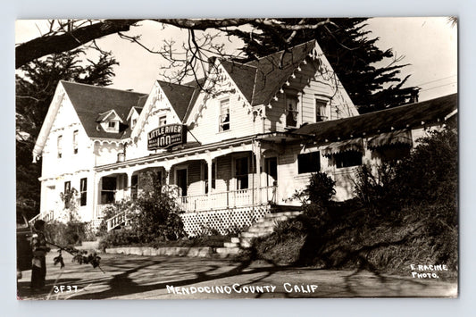 Postcard front showing the Little River Inn hotel with wraparound porch and gabled Victorian façade, labeled Mendocino County Calif; E. Rancine photo credit, 1940s unposted.