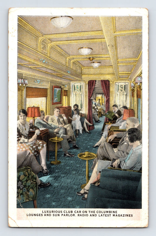 1931 postcard of Union Pacific Columbine lounge club car interior with upholstered seating, brass tables, shaded lamps, and passengers seated along central aisle