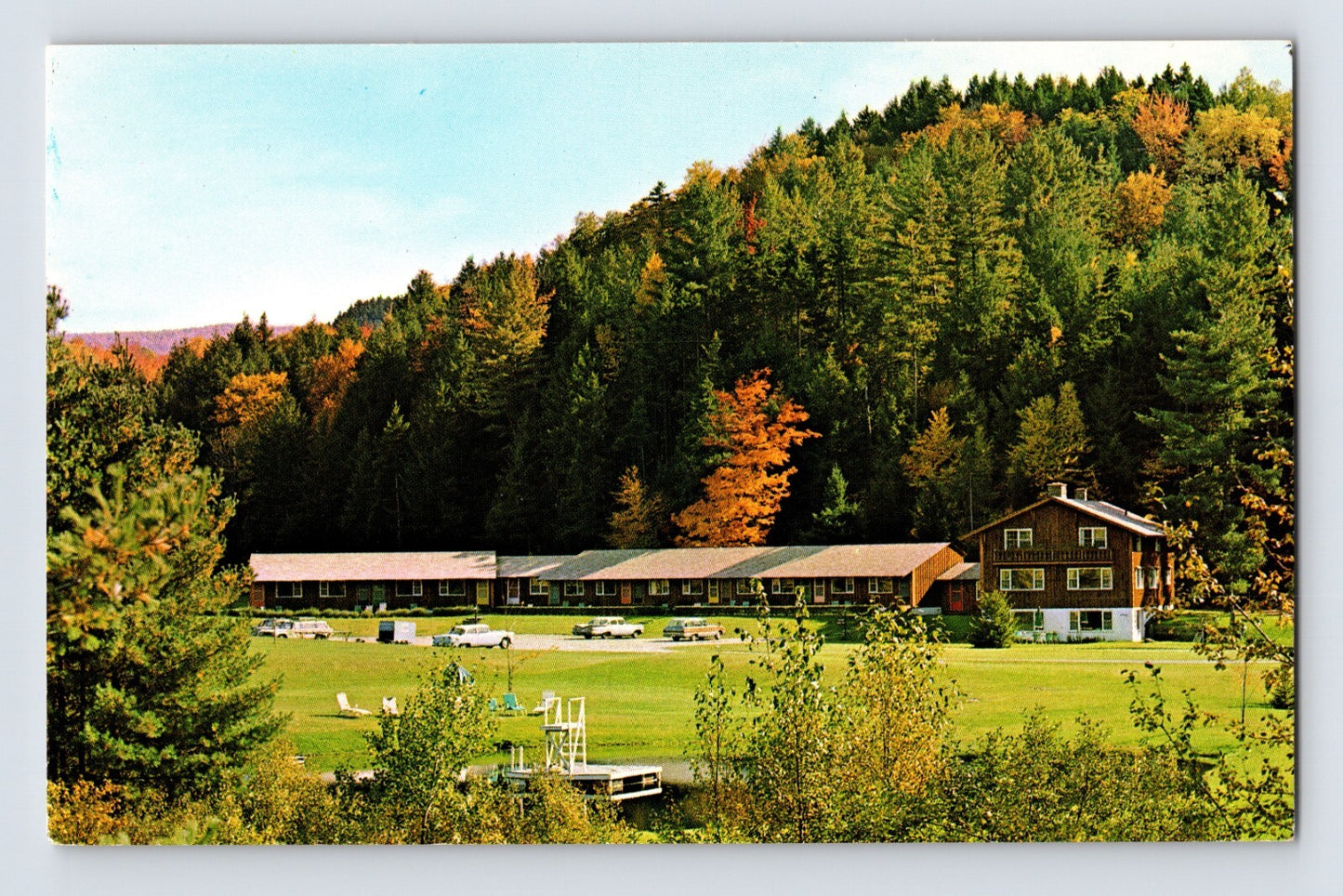 Madbush Chalet Hotel Waitsfield Vermont lodge with cars and lawn in fall foliage mountain setting