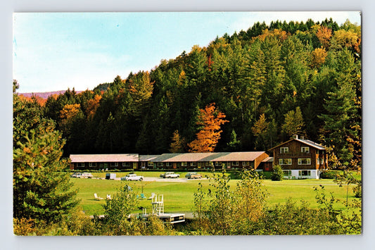 Madbush Chalet Hotel Waitsfield Vermont lodge with cars and lawn in fall foliage mountain setting