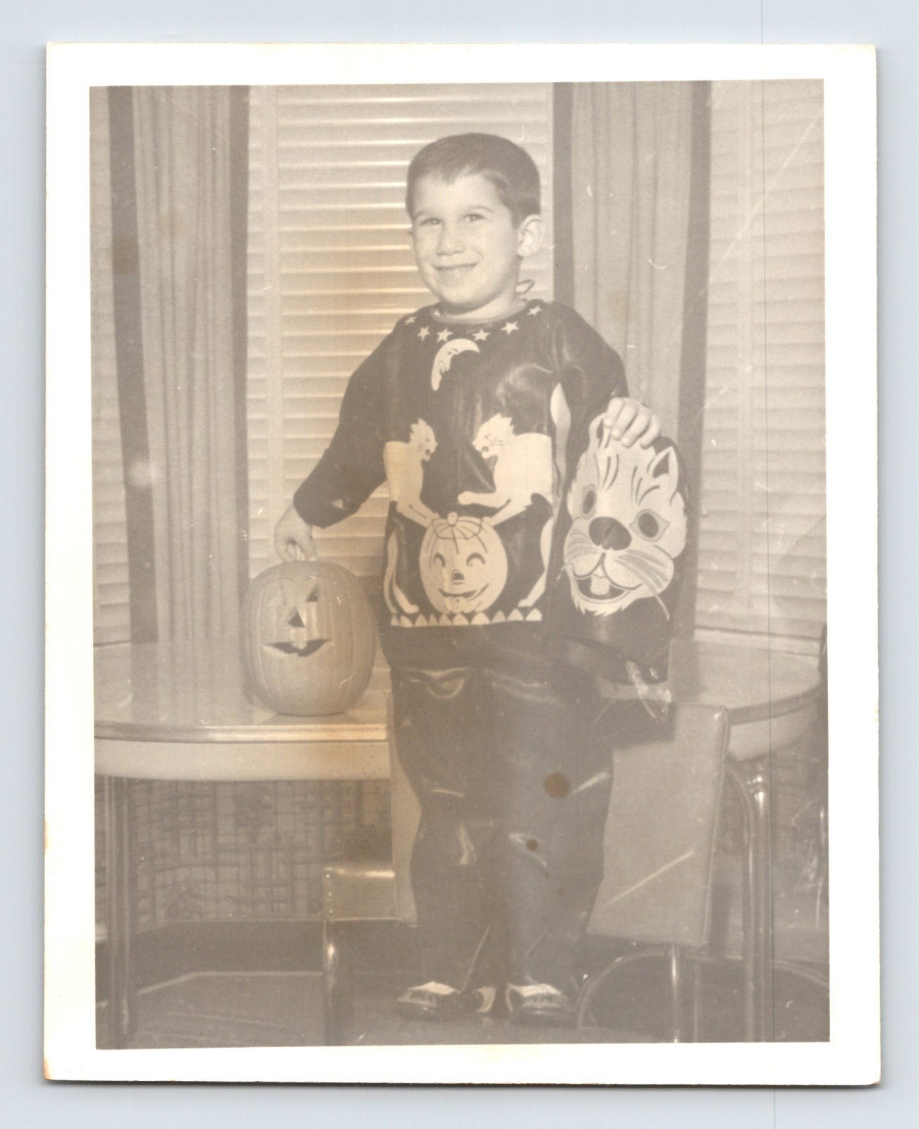 Boy Halloween costume holding cat mask jack o lantern indoors snapshot photo 4 x 5