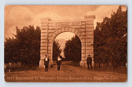 Yountville California Veterans Home entrance postcard showing the stone arch gateway with figures standing beneath the entrance drive.