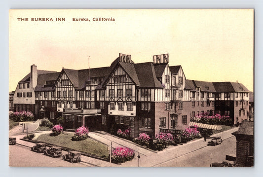 Eureka California Inn hotel Tudor style building with cars 1930s hand colored postcard
