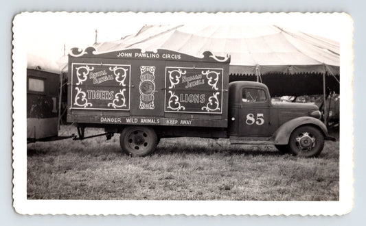 1949 John Pawling Circus truck with wild animal cage panel lettering for tigers and lions parked beside circus tent, 5.5 x 3.5 photograph