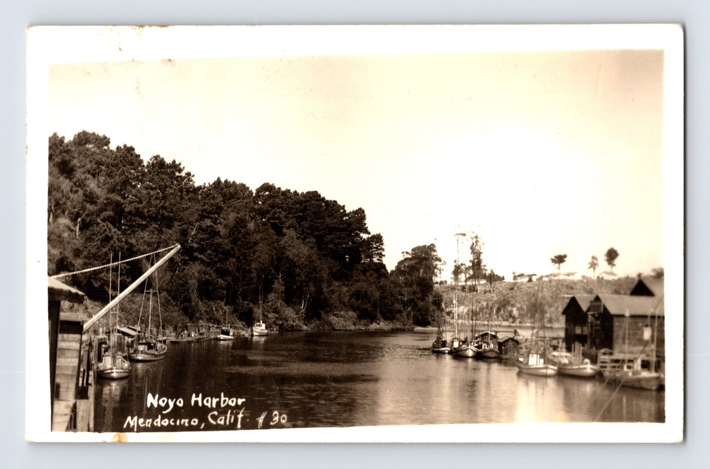 Noyo Harbor with fishing boats and waterfront buildings Mendocino California RPPC 1947 posted