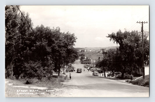 Limestone Maine street scene with automobiles utility poles trees 1950s RPPC 