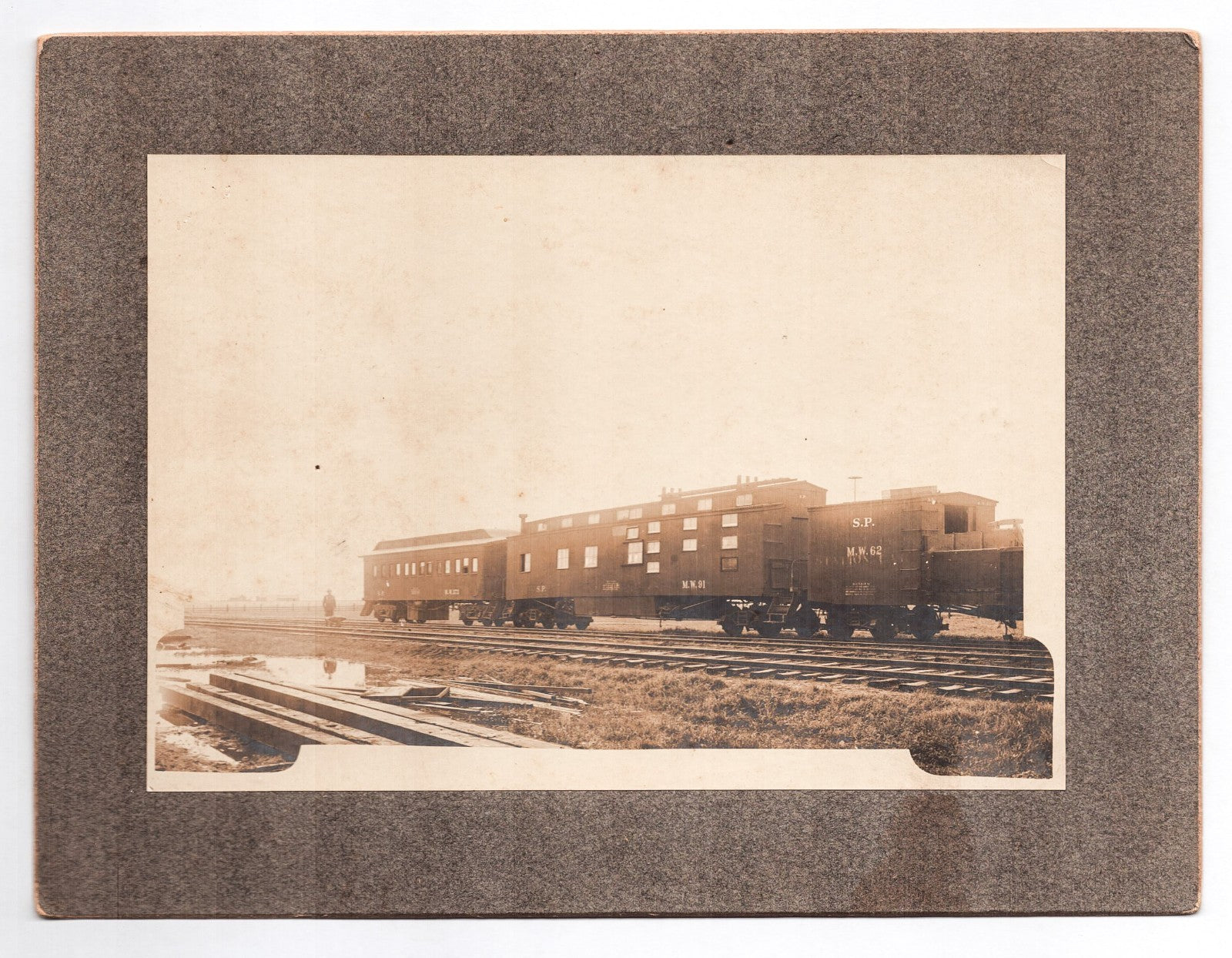 Vintage photograph of a train on tracks with a brown border