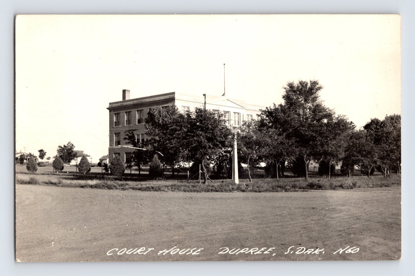 Dupree South Dakota courthouse photo 1940s showing two story government building with trees and open foreground