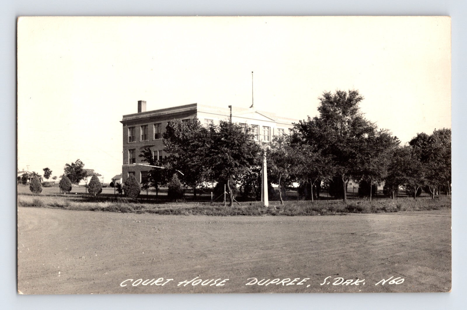Dupree South Dakota courthouse photo 1940s showing two story government building with trees and open foreground