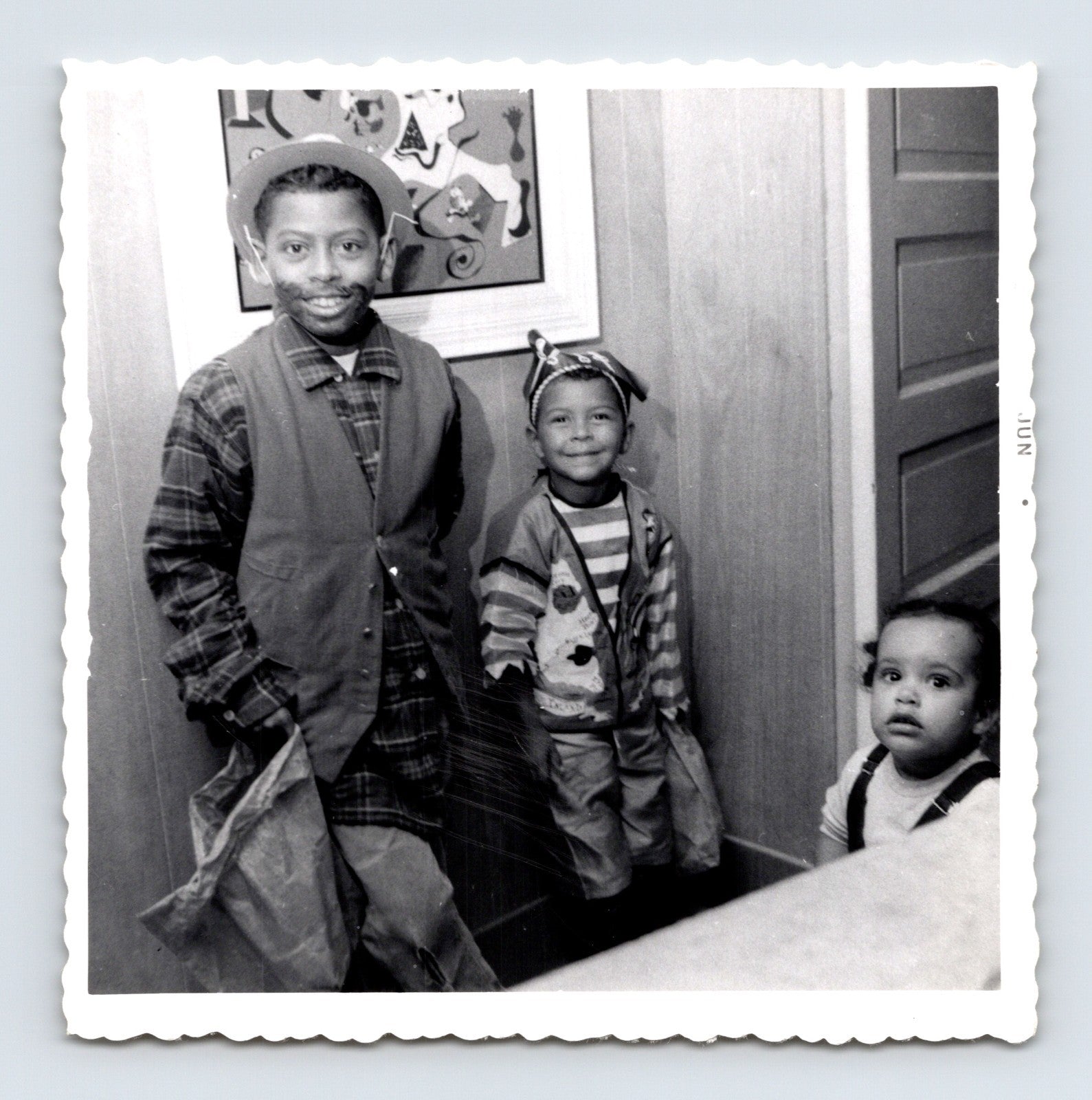 Vintage Halloween snapshot three children costumes trick or treat bags 1950s black white photo