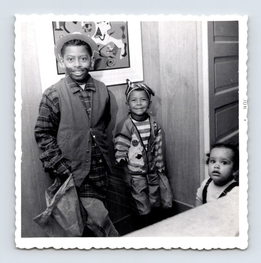 Vintage Halloween snapshot three children costumes trick or treat bags 1950s black white photo