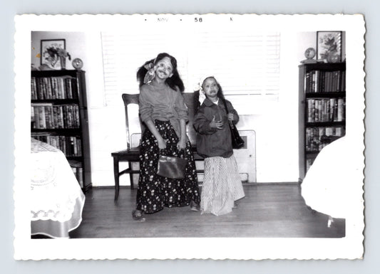 Two girls Halloween costumes face paint holding purses indoor living room 1958 snapshot photo
