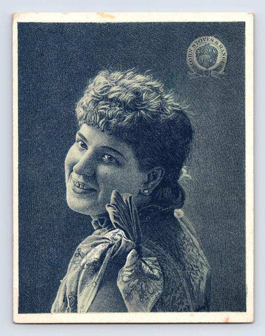Acorn Stoves and Ranges trade card featuring blue-toned Victorian woman portrait with advertising reverse for Rathbone Sard Company, 1890s era.