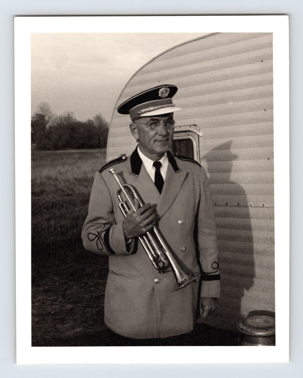 Mills Bros Circus band leader Joe Steffan holding trumpet beside trailer 1964 candid photograph