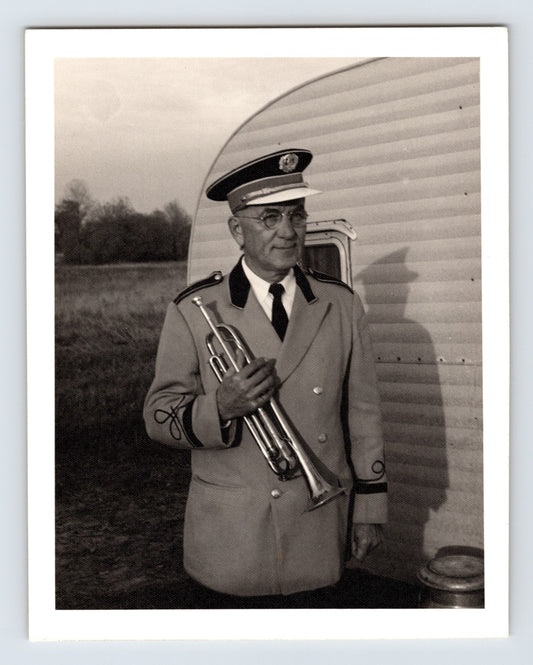 Mills Bros Circus band leader Joe Steffan holding trumpet beside trailer 1964 candid photograph